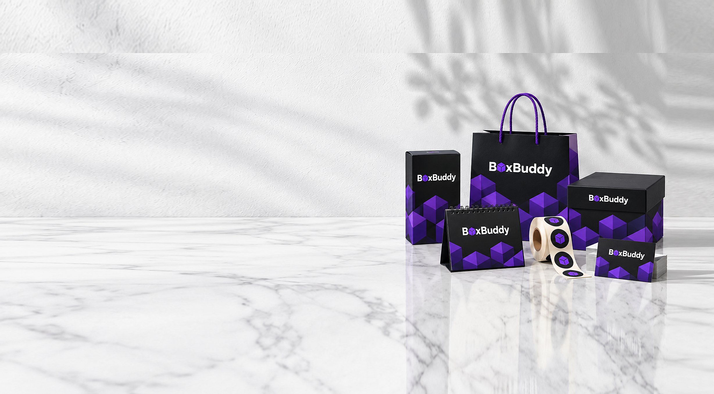 ชุดบรรจุภัณฑ์ BoxBuddy — กล่องบรรจุภัณฑ์ ถุงกระดาษหูเชือก ปฏิทินตั้งโต๊ะ 2027 สติ๊กเกอร์ฉลากสินค้าแบบม้วน นามบัตร และการ์ดขอบคุณ พิมพ์โลโก้สีกรมท่าบนกระดาษสีขาว